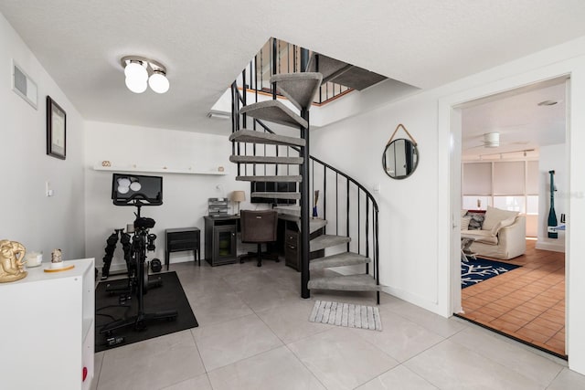 interior space featuring tile patterned flooring and a textured ceiling