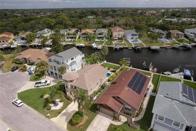 birds eye view of property with a water view and a residential view