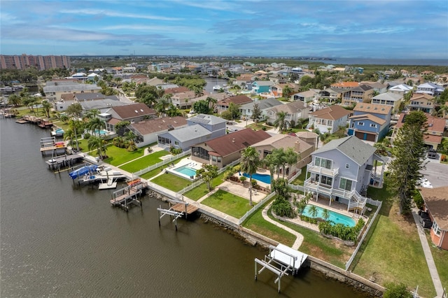 drone / aerial view with a water view and a residential view