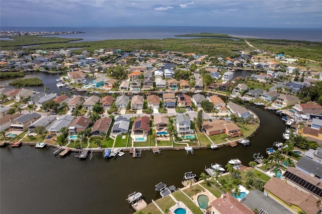 birds eye view of property with a water view and a residential view