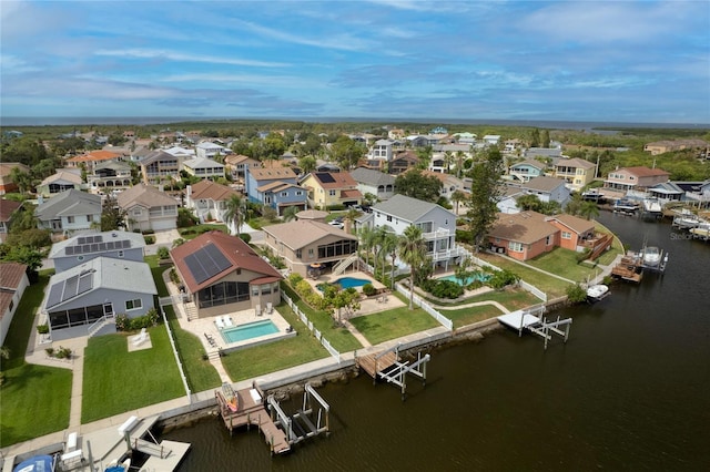 birds eye view of property with a water view and a residential view