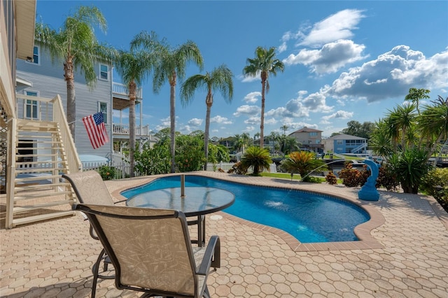 pool featuring a patio area and stairway