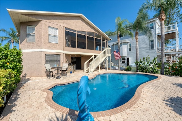 view of pool featuring a patio and a sunroom