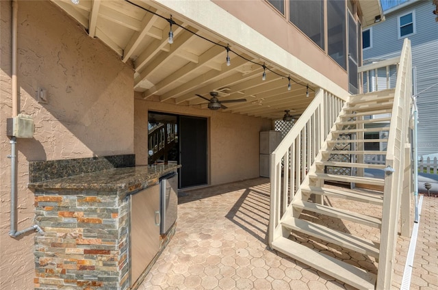 exterior space with ceiling fan, a patio area, and stucco siding