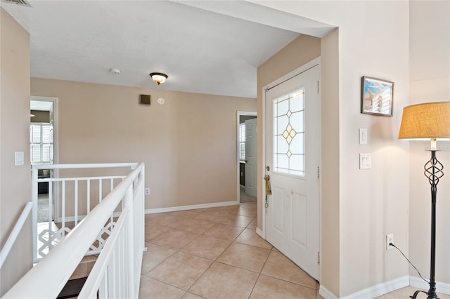 tiled entrance foyer featuring plenty of natural light