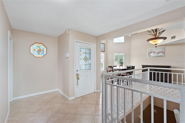 entrance foyer featuring light tile patterned floors, baseboards, and visible vents