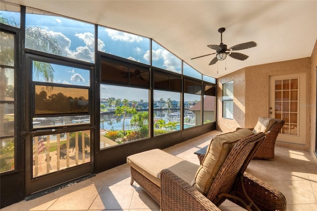 sunroom featuring a water view and ceiling fan