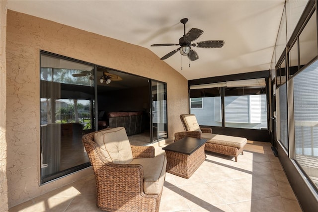 sunroom featuring ceiling fan and vaulted ceiling