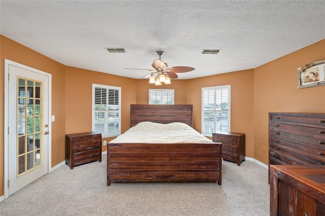 bedroom with baseboards, ceiling fan, visible vents, and light colored carpet