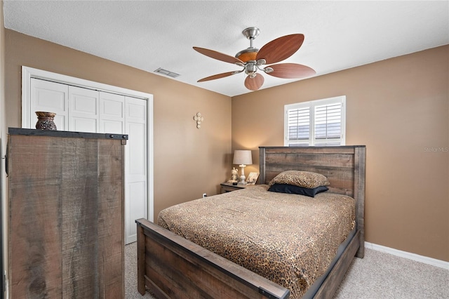 carpeted bedroom with ceiling fan, visible vents, and baseboards