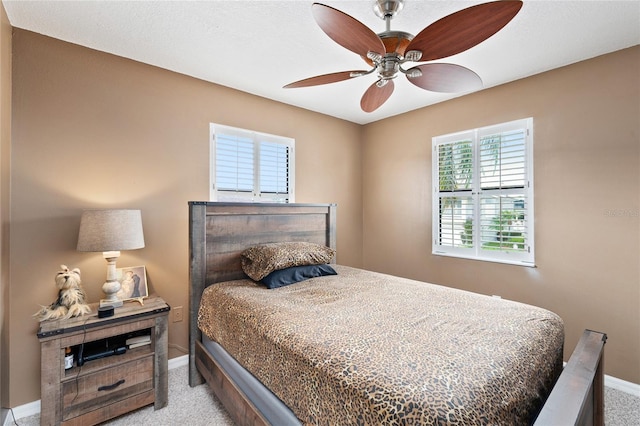 bedroom featuring light colored carpet and ceiling fan