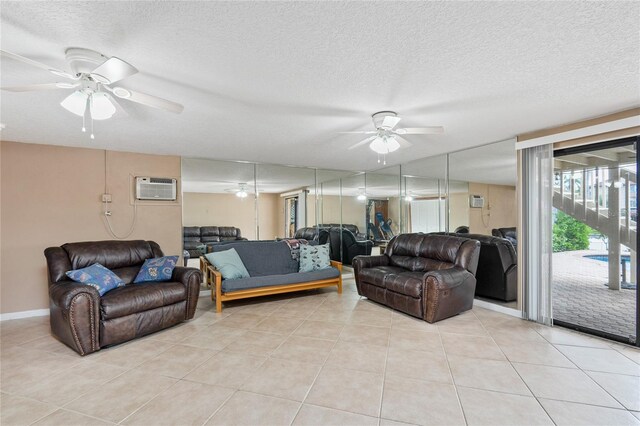 living room featuring ceiling fan, an AC wall unit, and a textured ceiling