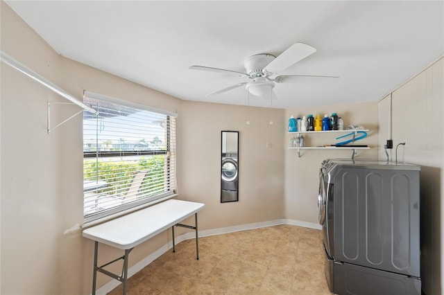 laundry room featuring ceiling fan, light tile patterned floors, and washing machine and clothes dryer