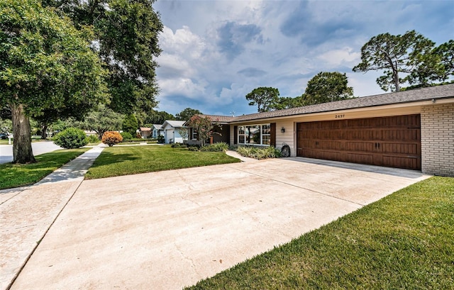 ranch-style house featuring a front yard and a garage