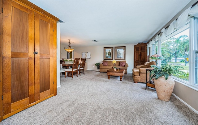 carpeted living room featuring a healthy amount of sunlight