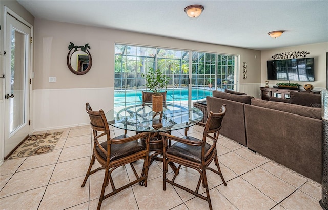 tiled dining space with a textured ceiling