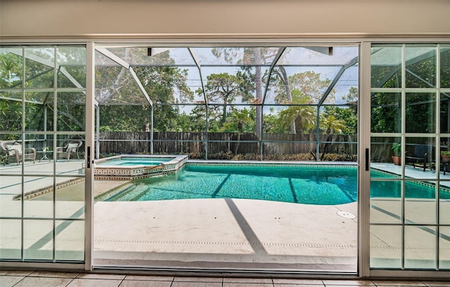 view of swimming pool featuring a patio area, glass enclosure, and an in ground hot tub