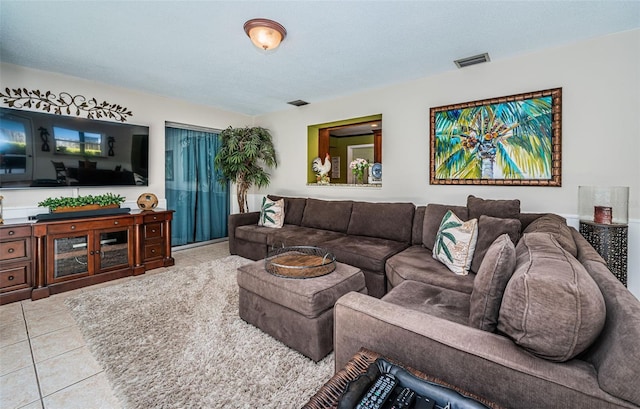 living room with light tile patterned floors and a textured ceiling