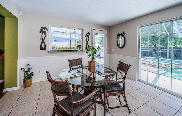 dining room featuring light tile patterned floors and a textured ceiling