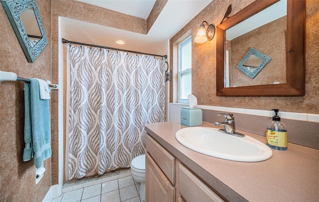 bathroom with tile patterned floors, a shower with curtain, toilet, and vanity