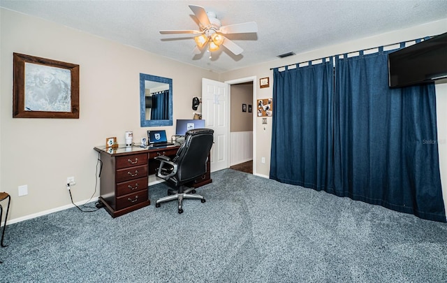 carpeted office featuring a textured ceiling and ceiling fan