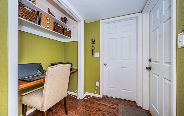 home office with dark wood-type flooring