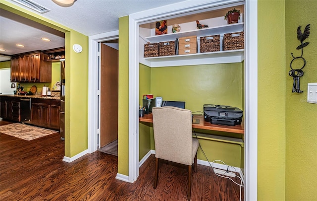 office area with a textured ceiling and dark hardwood / wood-style floors