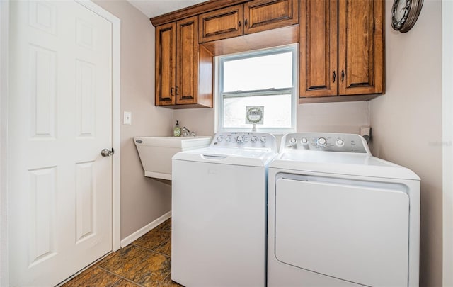 laundry area featuring cabinets and washer and clothes dryer