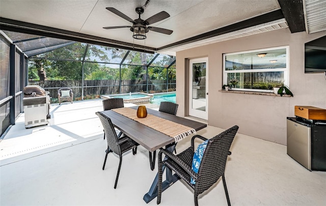 sunroom / solarium featuring ceiling fan