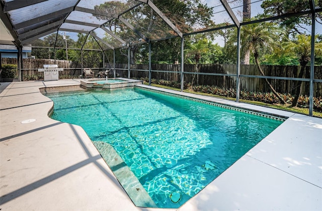 view of swimming pool featuring glass enclosure, an in ground hot tub, a grill, and a patio area