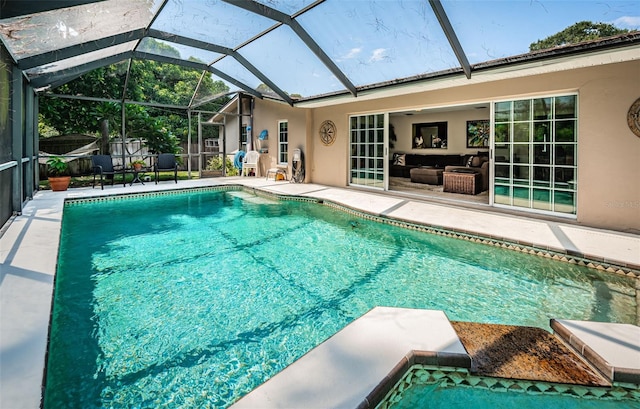 view of swimming pool featuring a lanai and a patio area