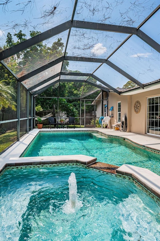 view of swimming pool with a lanai and a patio area