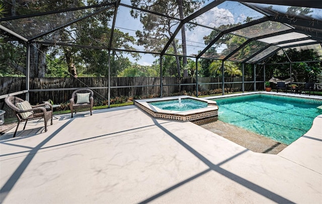 view of swimming pool with glass enclosure, an in ground hot tub, and a patio