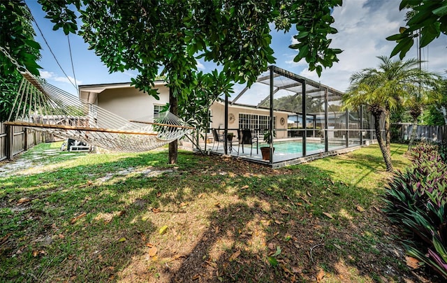 exterior space with glass enclosure, a fenced in pool, and a patio