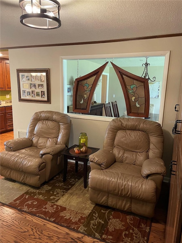 living room featuring a textured ceiling and hardwood / wood-style flooring