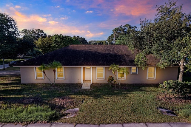 ranch-style house featuring a lawn