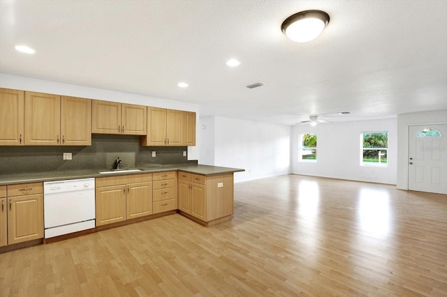 kitchen with white dishwasher, light hardwood / wood-style floors, sink, ceiling fan, and decorative backsplash