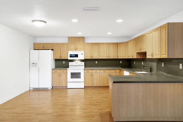 kitchen with light wood-type flooring, white appliances, backsplash, and sink