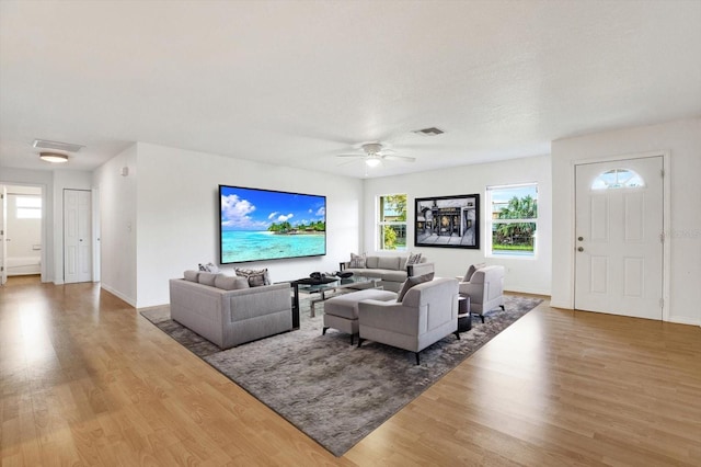 living room with hardwood / wood-style floors and ceiling fan