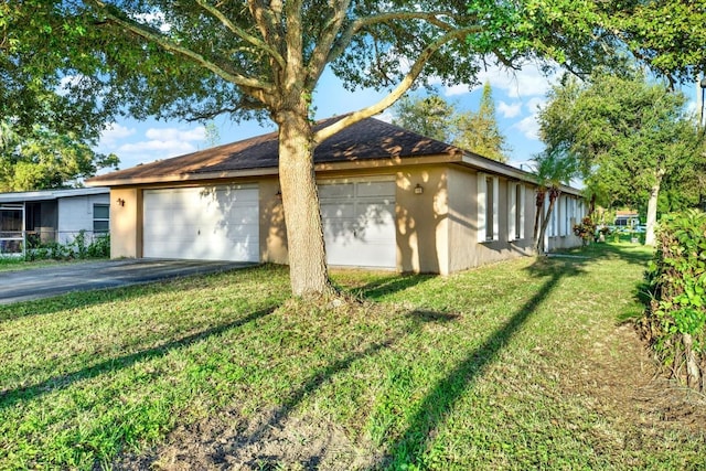 view of side of property with a yard and a garage