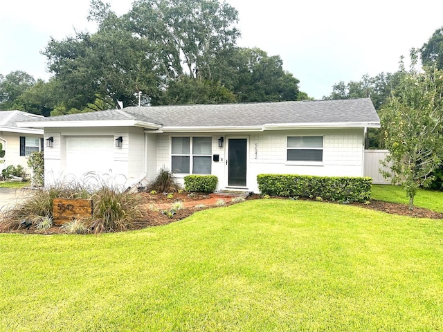 ranch-style home with a front yard and a garage