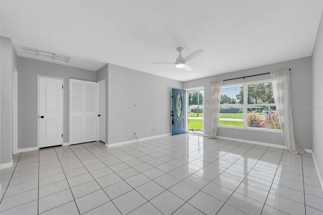 empty room featuring ceiling fan and light tile patterned floors