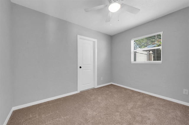 empty room with carpet flooring and ceiling fan