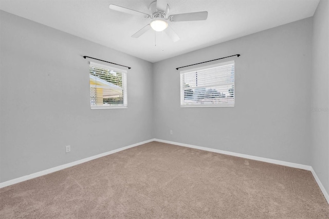 spare room with carpet flooring and ceiling fan