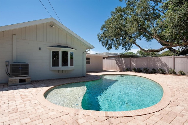 view of swimming pool featuring central AC unit and a patio area