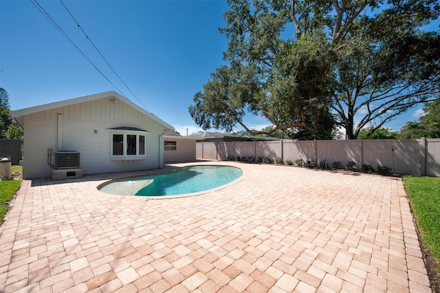 view of swimming pool featuring a patio area and central air condition unit