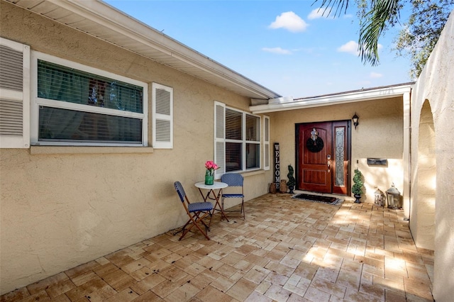 doorway to property with a patio area