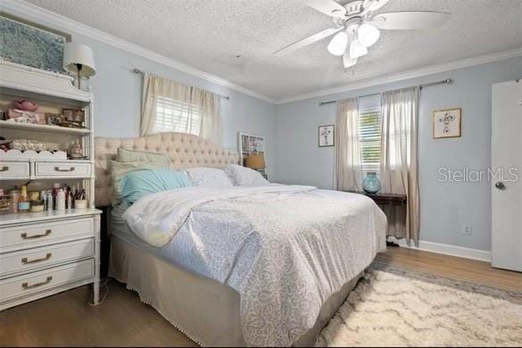 bedroom with hardwood / wood-style floors, ceiling fan, ornamental molding, and a textured ceiling