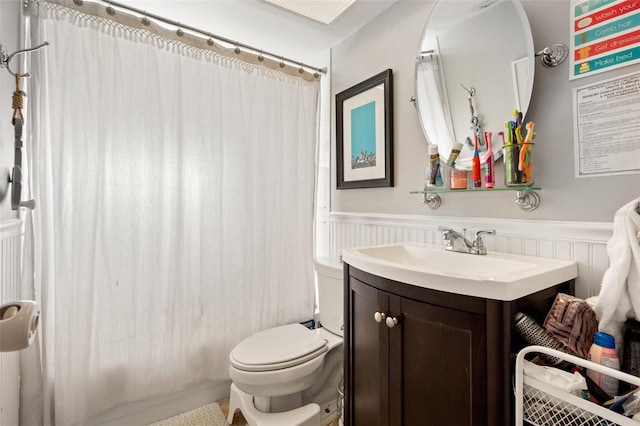 bathroom featuring a shower with curtain, toilet, and vanity