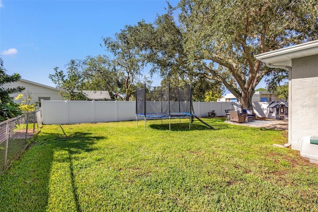 view of yard with a patio and a trampoline